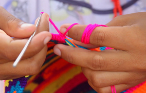 Wayuu woman sewing a mochile